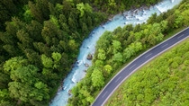 The whitewater river Steyr next to a paved road. The water is still blue from the melting snow in the montains in springtime. Location: next to the small ski resort Hinterstoder in the "Totes Gebirge" area in Upper Austria.